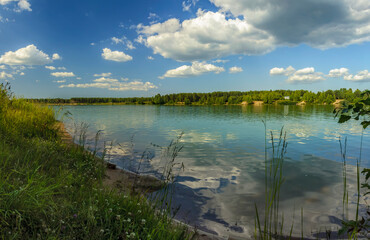 Summer vacation on the banks of an old quarry with turquoise water.