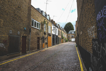 Beautiful brown brick alley with rows of small english houses in the Notting Hill, London