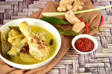 Opor ayam, chicken cooked in coconut milk from Indonesia, from Central Java, served with sambal. Popular dish for lebaran or Eid al-Fitr