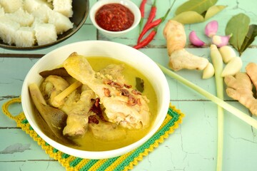 Opor ayam, chicken cooked in coconut milk from Indonesia, from Central Java, served with lontong and sambal. Popular dish for lebaran or Eid al-Fitr