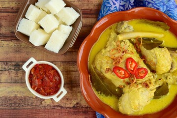 Opor ayam, chicken cooked in coconut milk from Central Java, Indonesia. Served with lontong (compressed rice cake). Popular dish for lebaran or Eid al-Fitr
