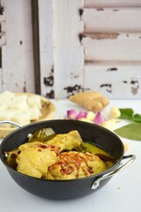 Opor ayam, chicken cooked in coconut milk from Central Java, Indonesia. Served with lontong (compressed rice cake). Popular dish for lebaran or Eid al-Fitr