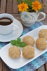 Sesame seed balls or Onde-onde. Indonesian traditional street food. glutinous rice flour stuffed with mung bean paste coated with sesame seeds. Served with a cup of coffee