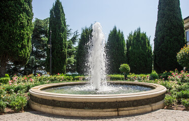 Street fountain in the park in summer.