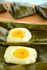 Nagasari, traditional steamed cake made from rice flour, coconut milk and sugar. Filled with sliced of banana. Wrapped in banana leaves
