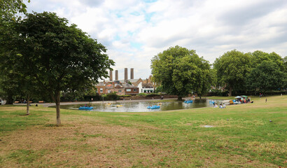Small pond used for summer fun with paddle boats in the park in town of Greenwich
