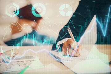 Double exposure of forex chart drawing over people taking notes background. Concept of financial analysis