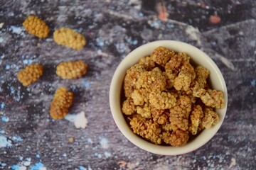 Dried mulberry on grey background