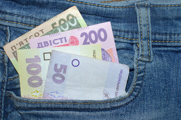 500, 200, 100, 50 hryvnia bills (UAH) in the front pocket of blue jeans. Money concept