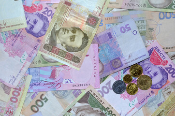 Many Ukrainian money bills of various denominations and colors and coins.  Modern Ukrainian money - hryvnia. UAH. Money background