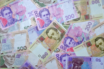 Fototapeta na wymiar Many Ukrainian money bills of various denominations and colors Modern Ukrainian money - hryvnia. UAH. Money background