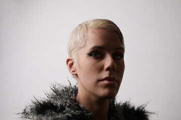 Close-up beauty portrait of stylish young model with short blonde hair.