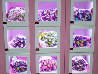 Bouquets of colorful flowers in small cells. Self-service vending machine. A gift for the holidays of the eighth of March, mothers ' day, Valentine's Day