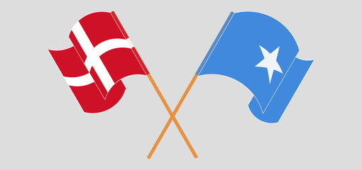 Obraz na płótnie Canvas Crossed and waving flags of Denmark and Somalia