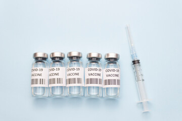 Ampoule Covid vaccine. Medicine vials and injection syringe. Vaccine against the new stamp of the virus. Medicine concept
