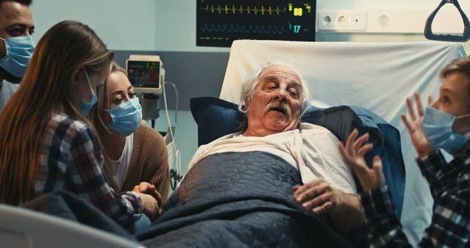 Senior patient speaking with family in clinic