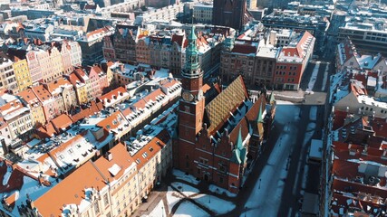 Old houses in historic part of town, Wroclaw, Poland. Famous red brick old town hall. High angle view from drone in winter. 