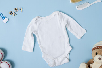 Top view white baby bodysuit mock up on a blue background. Your design or logo placement