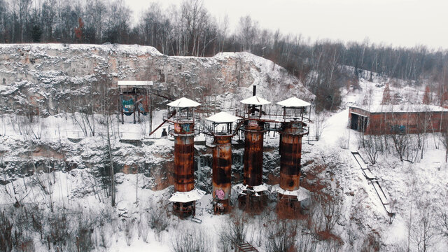 Winter view of old rusty machinery and piping equipment in closed limestone Liban quarry Kamieniolom Liban in Krakow, Poland. 