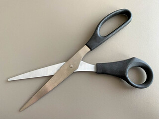 Black metal sharp scissors for paper on the working office table. Business work