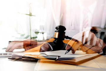 justice and law concept.Male judge in a courtroom on wooden table and Counselor or Male lawyer working in office. Legal law, advice and justice concept.