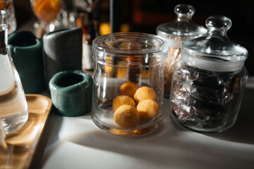 Four glass cups on the bar counter with serving accessories.