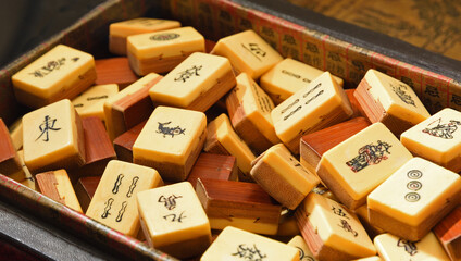 Vintage Bone and bamboo  Mahjong or mah-jongg playing tiles in box. Close up Background.