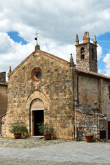 Stone, medieval church with a bell tower in the village of Monteriggioni in Toscana