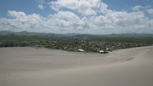 Settlement at the foot of sand dunes in Fiji, South Pacific 
