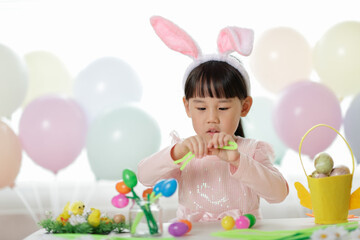 young girl making easter craft at home