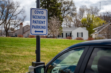 COVID vaccination site with sign and empty parking