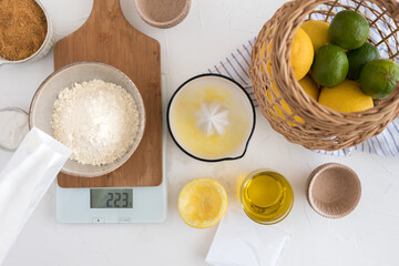 Fresh muffin ingredients deployed on a white rustic table.