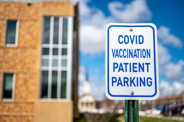 COVID vaccination site with sign and empty parking