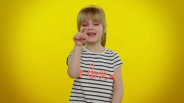 Hey, you. Funny playful blonde kid child smiling excitedly and pointing to camera, beauty choosing lucky winner, indicating to awesome you on yellow studio background. Teenager children girl emotions