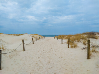 Path towards beach with white sand in Slowinski national park, Baltic coast of Poland
