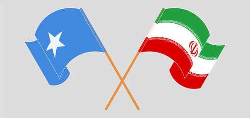 Crossed and waving flags of Somalia and Iran