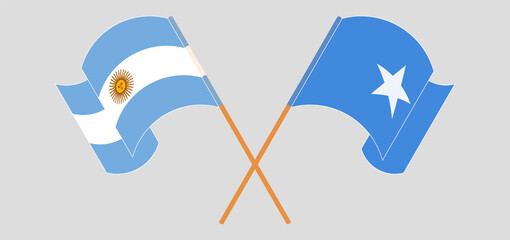 Crossed and waving flags of Argentina and Somalia