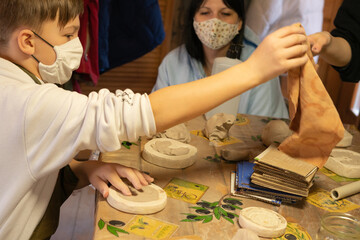 The boy is studying pottery. Clay modeling master class. Carpathians. Ukraine.