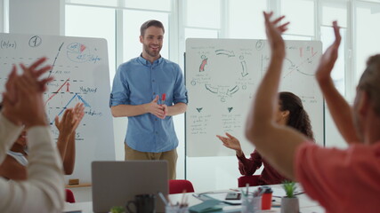 Smart colleague celebrating success office. Business people applauding speaker