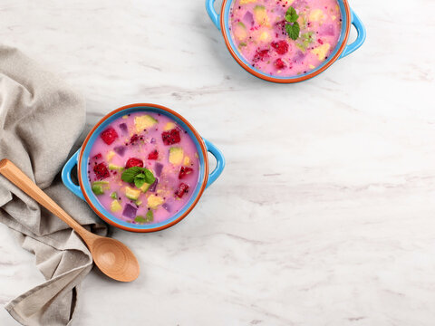 Top View Ready to Eat Sop Buah or Es Buah is Mixed Fruit with Coconut or Simple Syrup, Served with Shaved Ice and add Condensed Milk. Popular for Buka Puasa (Breakfasting), Copy Space for Text