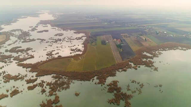 Aerial drone shot of untouched nature in Serbia, at dawn. Reed, bulrush islands.