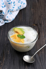 Es Teler, Traditional Indonesian Ice Dessert of Tropical Fruit Cocktail in Sweet Coconut Water and Condensed Milk Served in Bowl