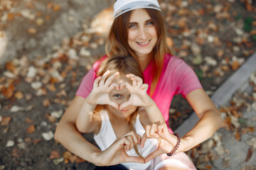 Mother with daughter playing in a summer park