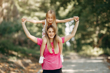 Obraz premium Mother with daughter playing in a summer park