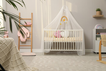 Fototapeta na wymiar Cozy baby room with crib and other furniture. Interior design