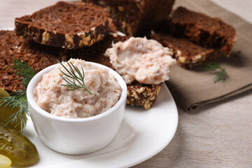 Delicious lard spread, bread and pickles on wooden table