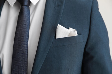 Man with handkerchief in suit pocket, closeup view