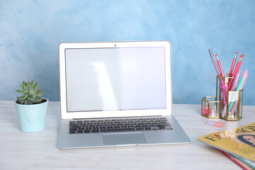 Modern laptop and stationery on white wooden table. Space for text - Powered by Adobe