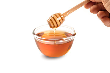 Honey in glass bowl isolated on white background.
