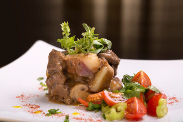 Timbal accompanied with tomatoes, gourmet dish